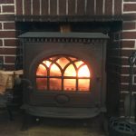 wood stove or fireplace - fire in woodburning stove in hearth