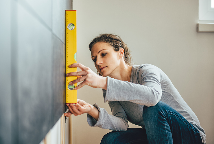 Woman measuring for gallery wall